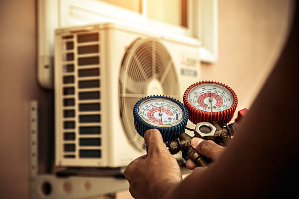 Professional Air Conditioning Service technician working in Strafford, NH